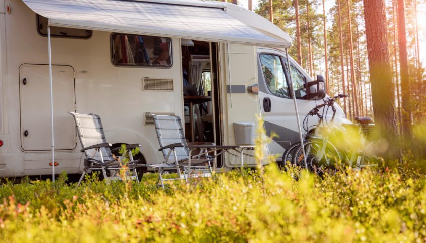 camping car ouvert avec des chaises de camping